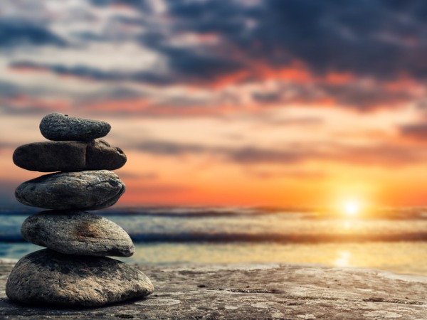 zen-pyramid-of-stones-on-the-background-of-sunset-and-sea.jpg